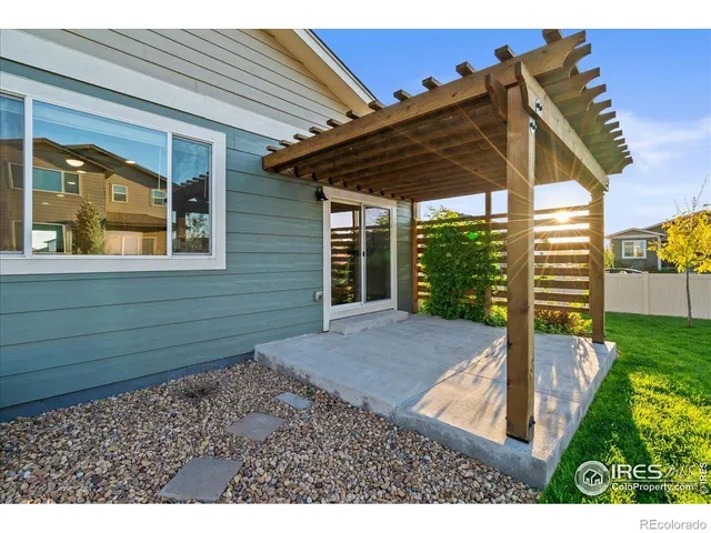 a view of a backyard with table and chairs and wooden fence
