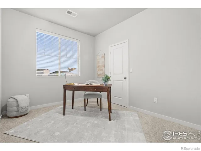 a workspace with furniture and window