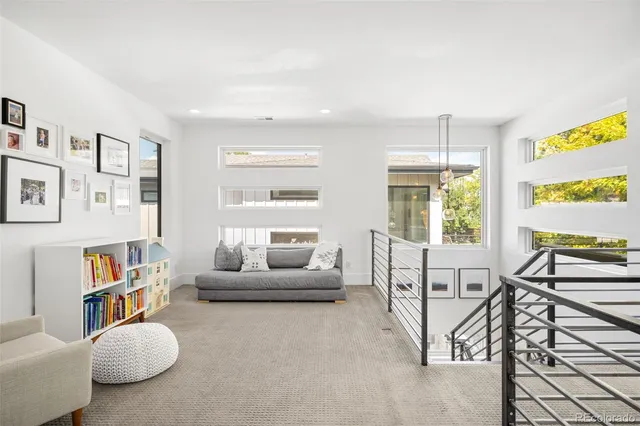 a living room with furniture and a floor to ceiling window