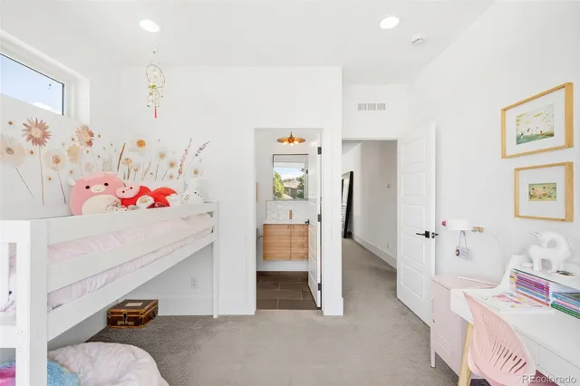 a bedroom with furniture and baby bed