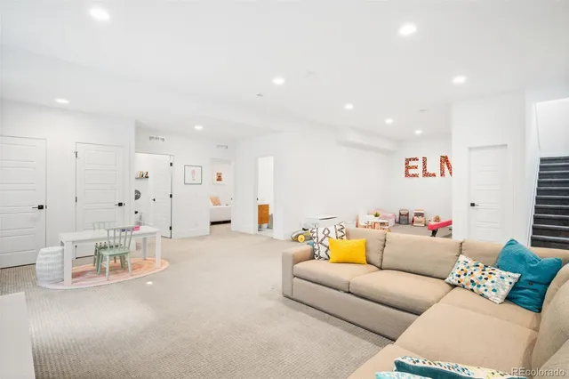 a living room with furniture and kitchen view