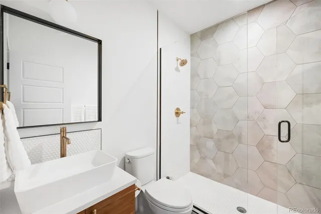 a bathroom with a toilet a sink and shower