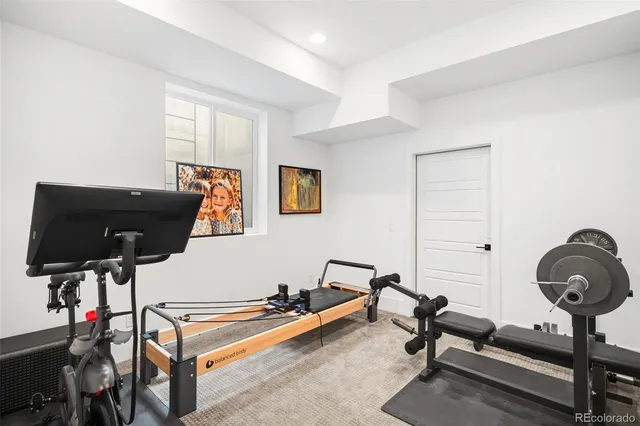 a living room with furniture and air hockey table