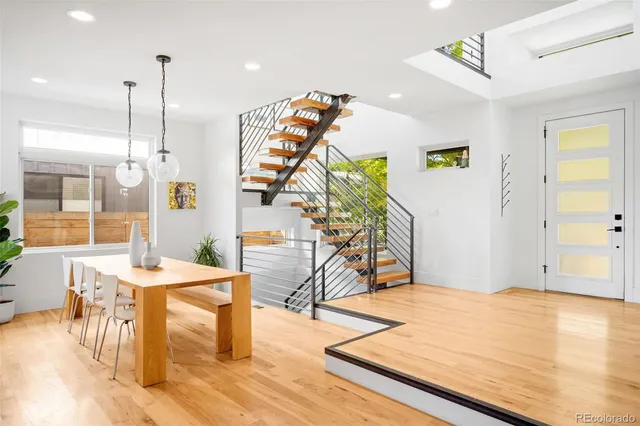 a view of a room with furniture and wooden floor