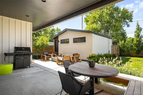 a view of a patio with table and chairs and potted plants