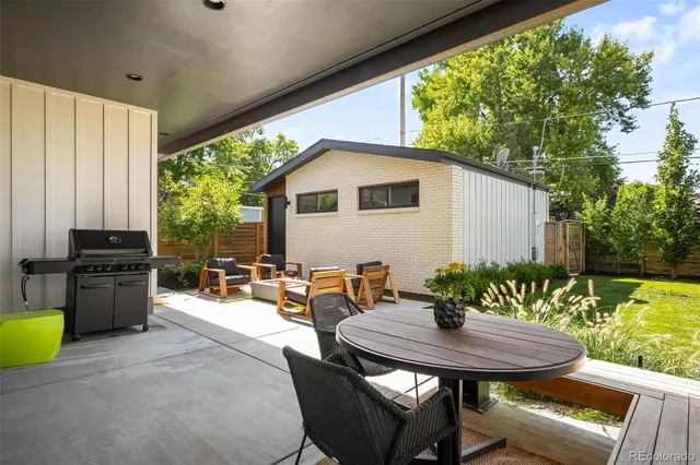 a view of a patio with table and chairs and potted plants