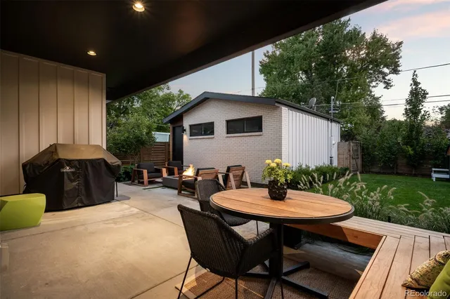 a view of a house with brick walls and a yard with plants