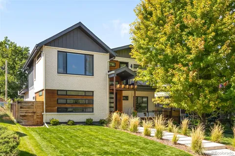 a kitchen with stainless steel appliances granite countertop a sink a stove and a wooden floors
