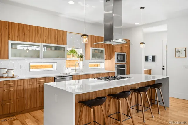 a kitchen with a table chairs and a wooden floor