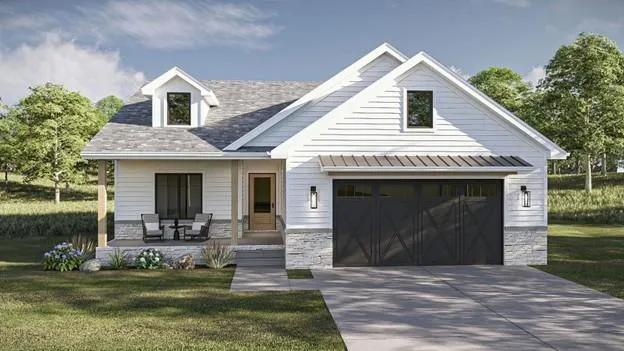 a front view of a house with a yard table and chairs