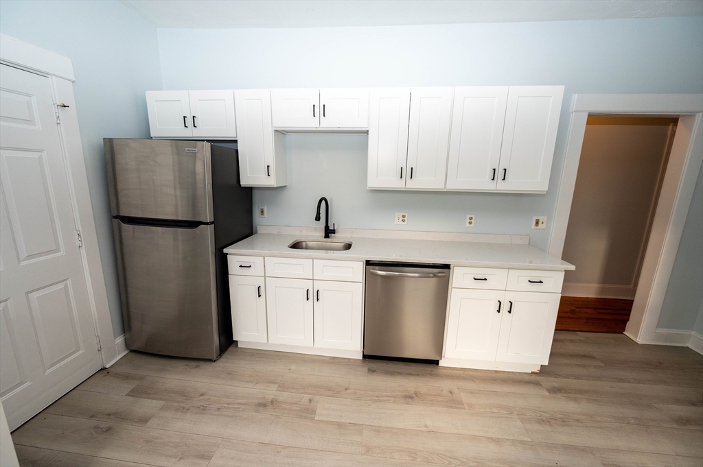 5 Colchester Street, Unit 2 Boston, MA 02136 - Photo 1 of 19 a kitchen with a refrigerator sink stove and cabinets