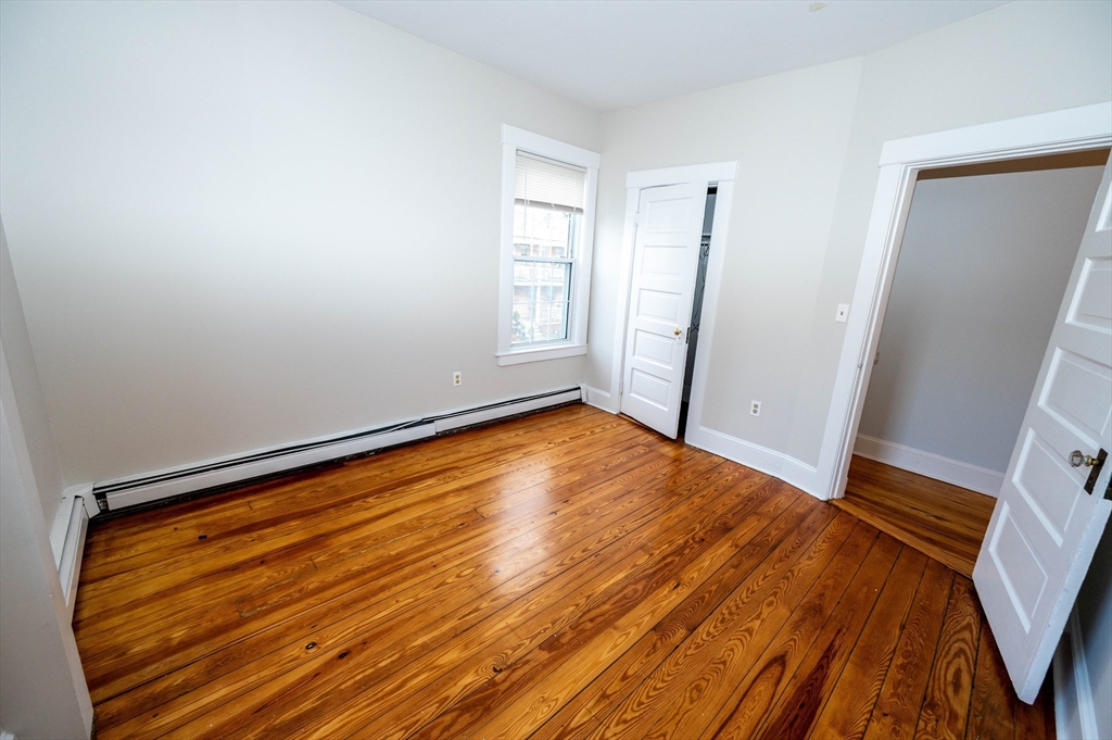 5 Colchester Street, Unit 2 Boston, MA 02136 - Photo 13 of 19 a view of empty room with wooden floor and fan