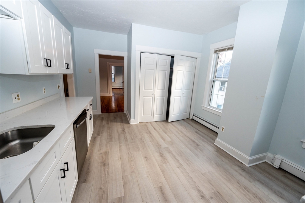 5 Colchester Street, Unit 2 Boston, MA 02136 - Photo 4 of 19 a hallway view with wooden floor and staircase