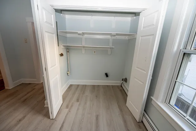 a view of a room with wooden floor