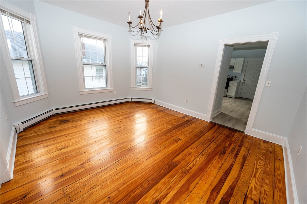 5 Colchester Street, Unit 2 Boston, MA 02136 - Photo 9 of 19 a view of an empty room with wooden floor and a window
