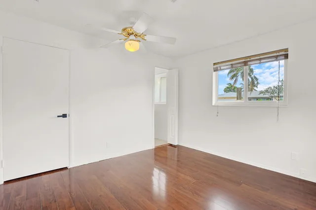 a view of wooden floor and window in a room