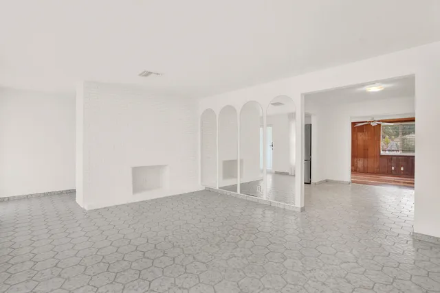 an empty room with windows and entrance