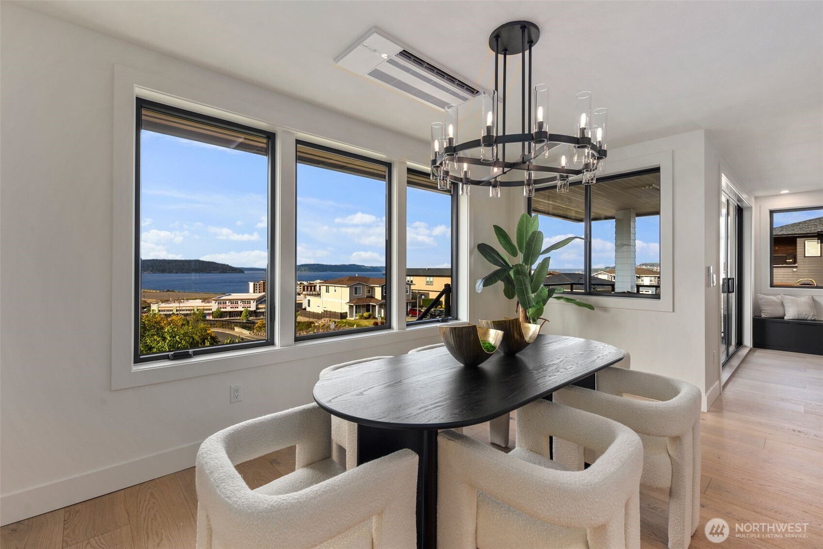 5301 North Commercial Street Ruston, WA 98407 - Photo 12 of 40 a dining room with furniture a chandelier and wooden floor