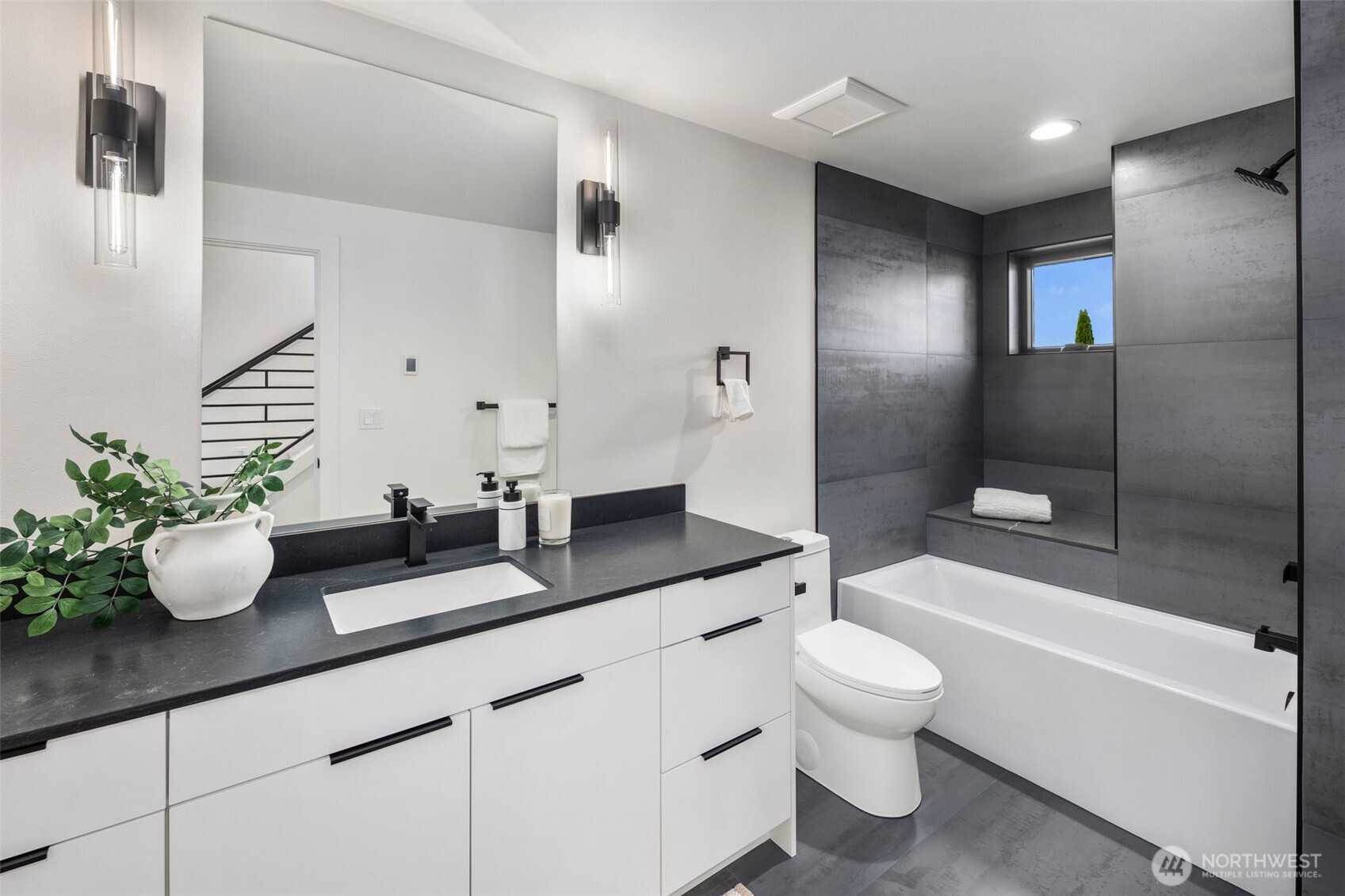 5301 North Commercial Street Ruston, WA 98407 - Photo 33 of 40 a bathroom with a granite countertop sink a toilet and shower