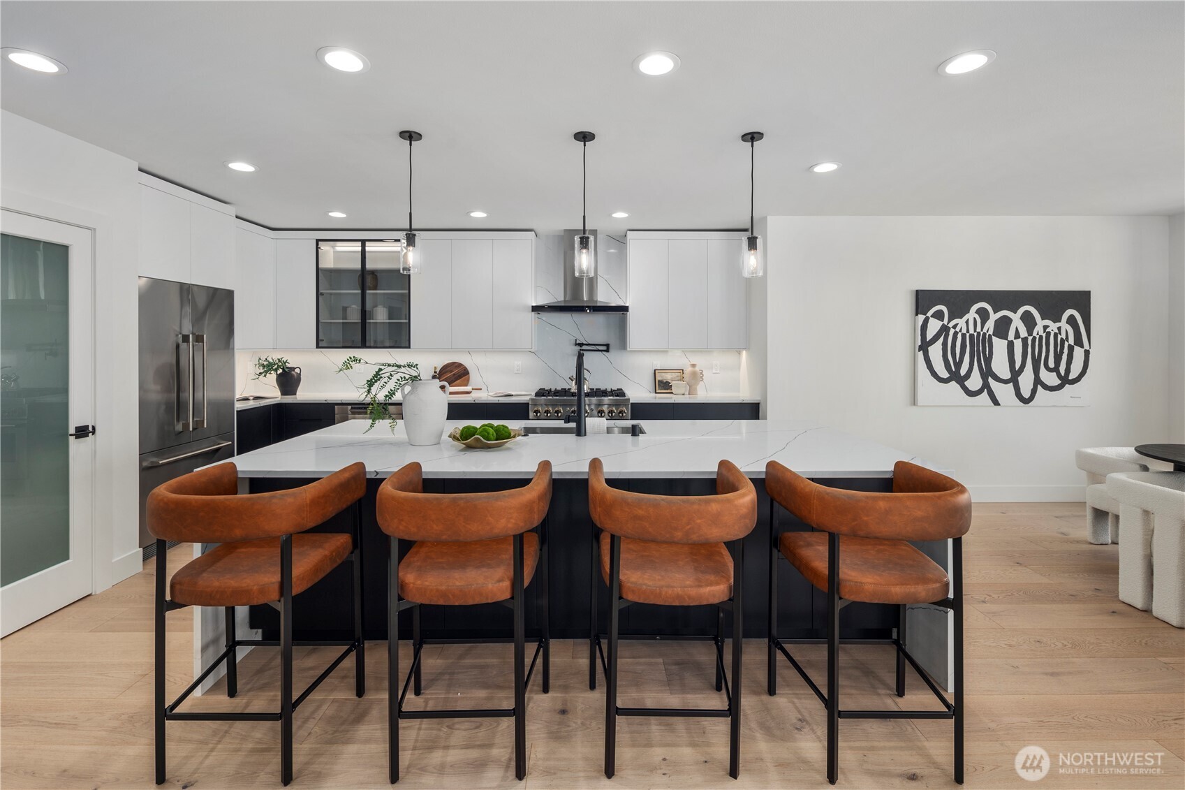 5301 North Commercial Street Ruston, WA 98407 - Photo 7 of 40 a dining room with stainless steel appliances kitchen island granite countertop a dining table chairs and a refrigerator