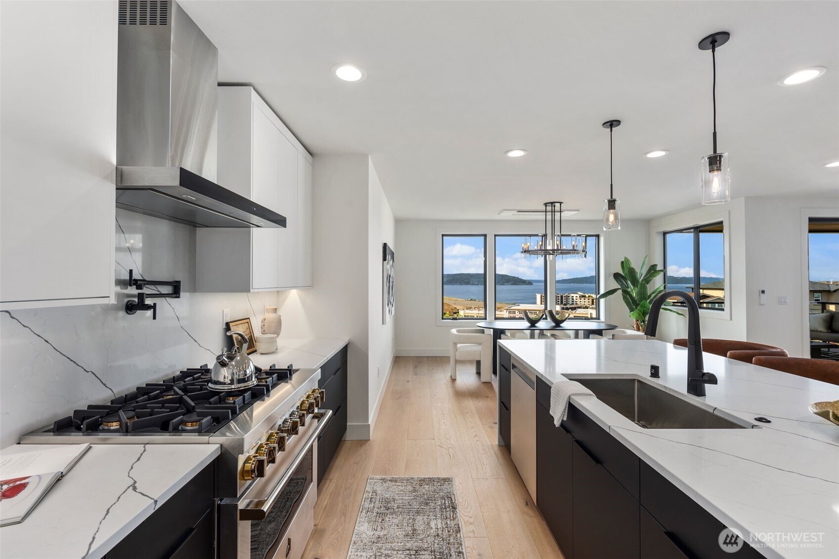 5301 North Commercial Street Ruston, WA 98407 - Photo 8 of 40 a kitchen with stainless steel appliances a sink stove and cabinets