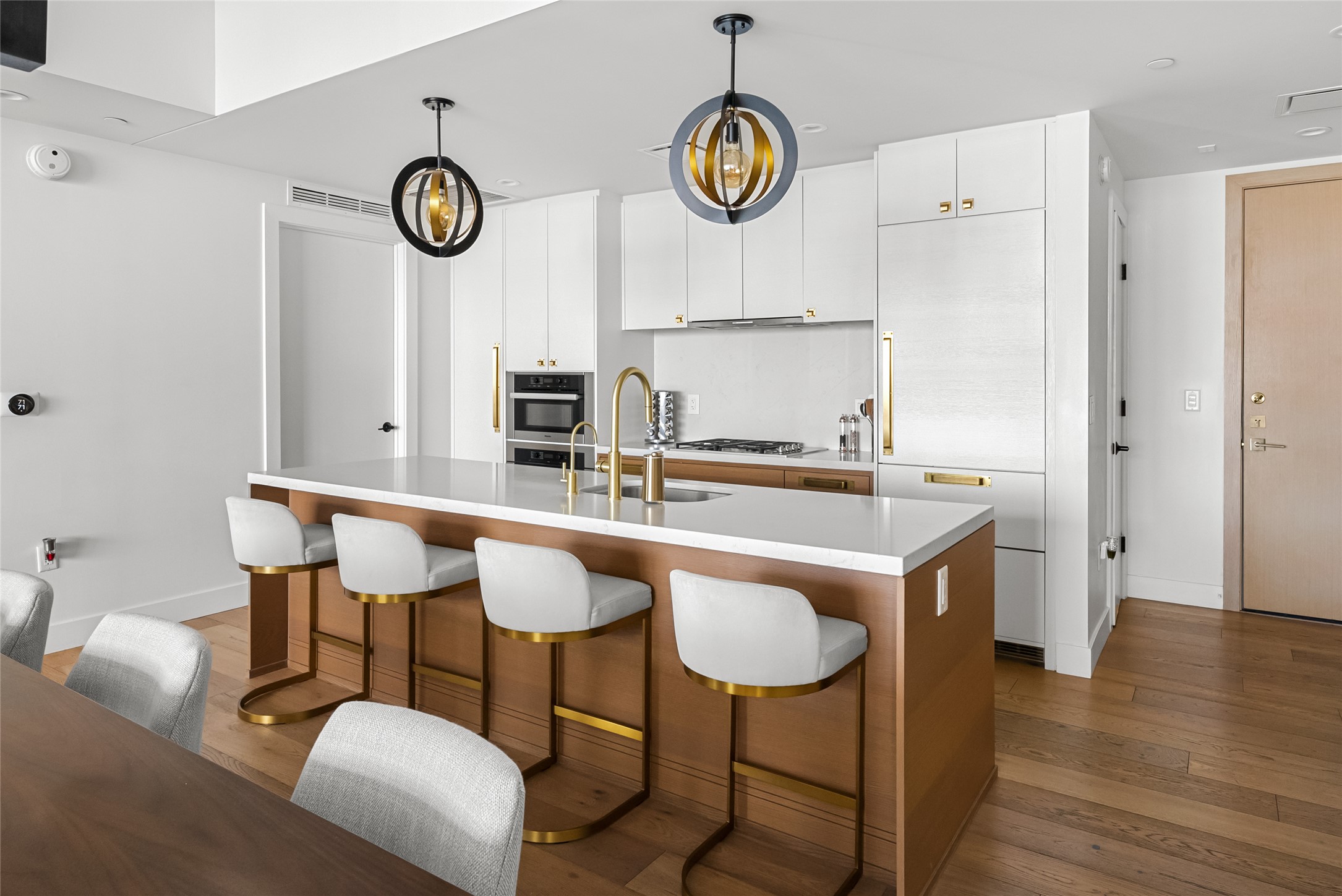 70 Rainey Street, Unit 2106 Austin, TX 78701 - Photo 2 of 26 a kitchen with a dining table and chairs