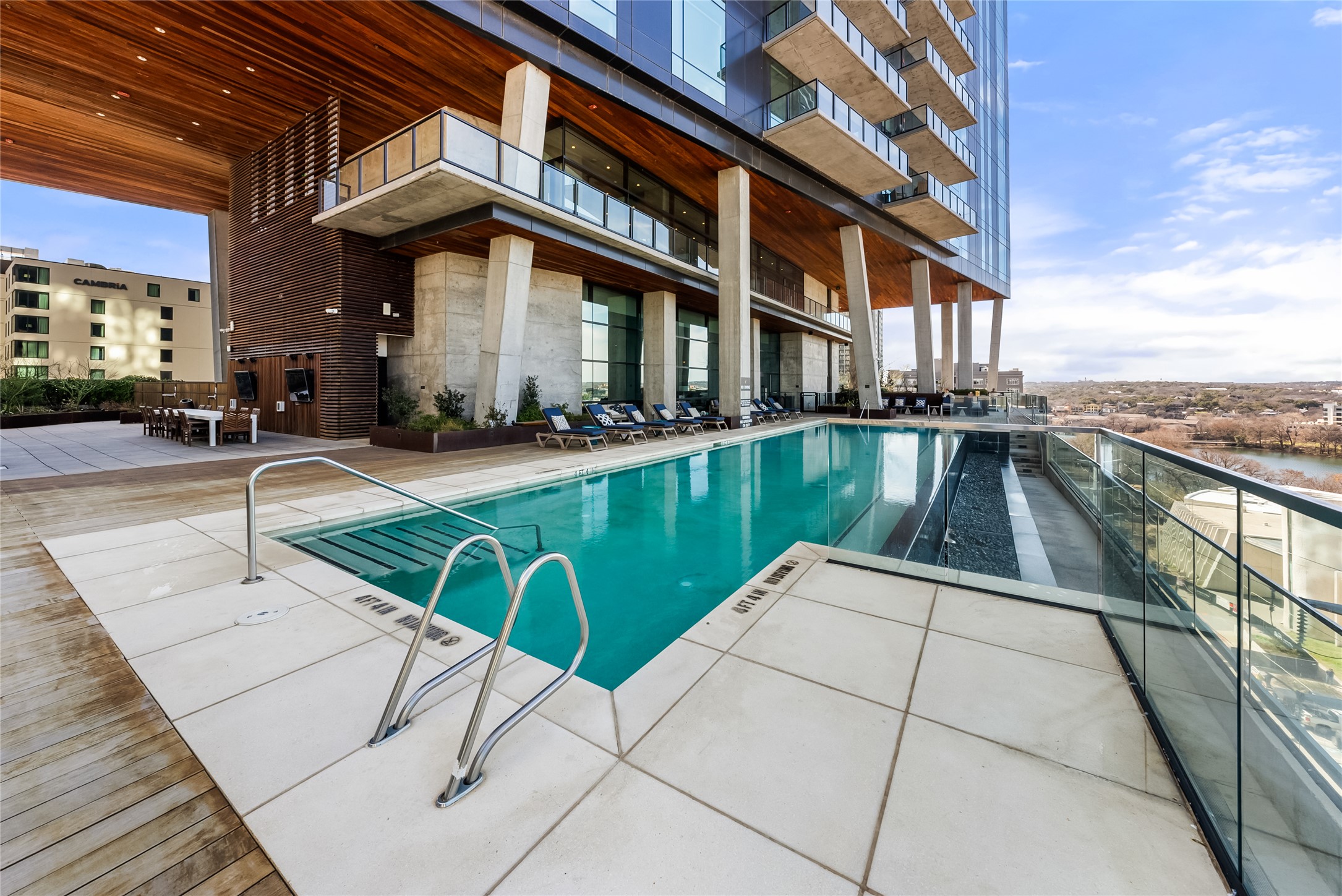 70 Rainey Street, Unit 2106 Austin, TX 78701 - Photo 22 of 26 a view of a patio with chairs and umbrellas on a brick house