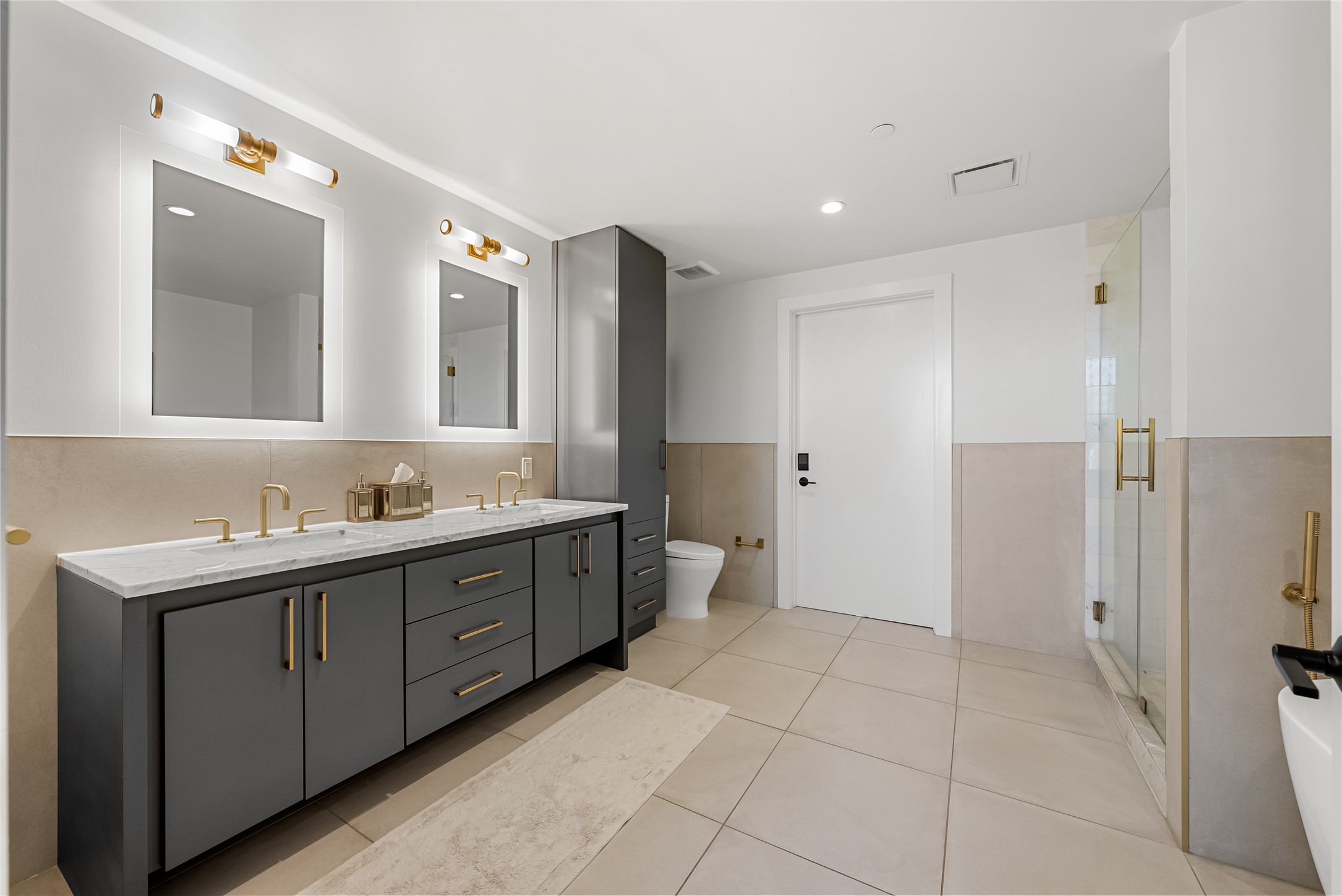 70 Rainey Street, Unit 2106 Austin, TX 78701 - Photo 7 of 26 a spacious bathroom with a mirror sink and double vanity