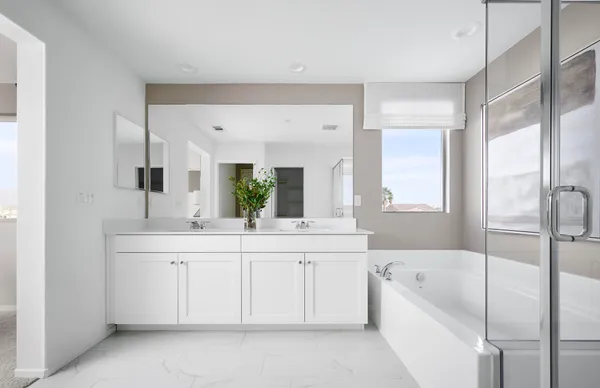 a spacious bathroom with a tub sink and mirror