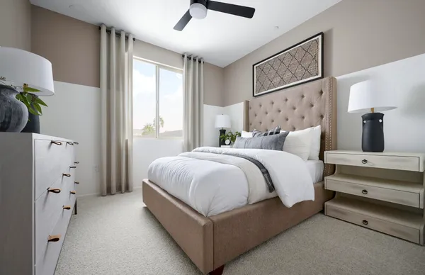 a spacious bedroom with a bed and a chandelier