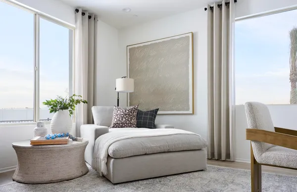 a bedroom with a bed and a potted plant