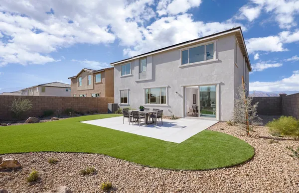 a view of a house with backyard sitting area and garden