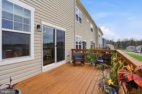 a view of two chairs and table in a balcony