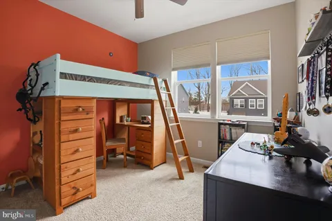 a view of a bedroom with a window and storage
