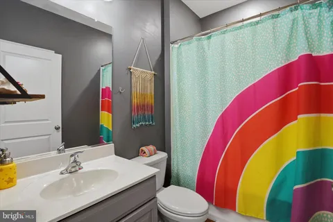 a bathroom with a sink mirror vanity and toilet