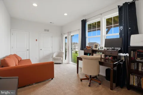 a living room with furniture a lamp and a window