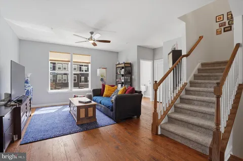 a living room with furniture windows and a flat screen tv