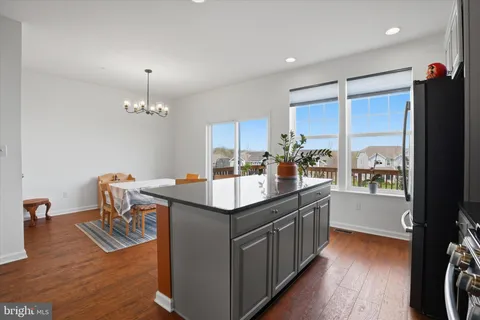 a kitchen with counter top space and wooden floor