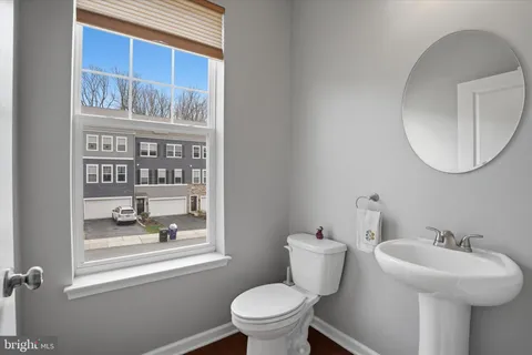 a bathroom with a sink a toilet and a mirror