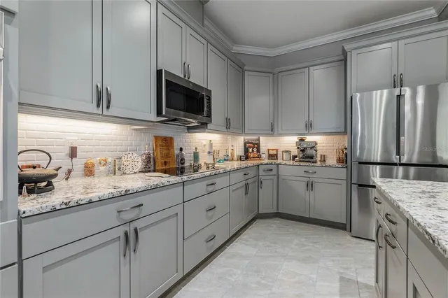 a kitchen with granite countertop cabinets stainless steel appliances and sink