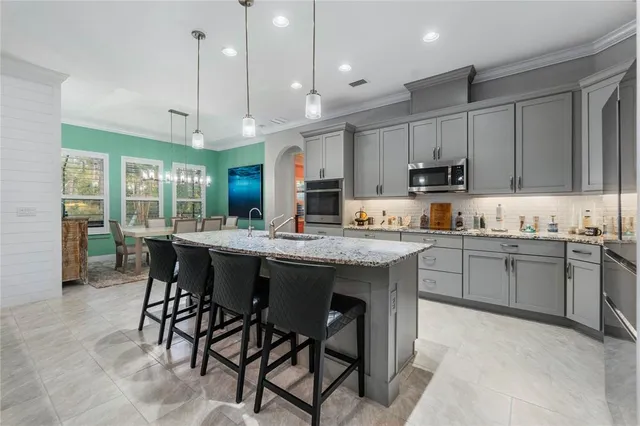 a kitchen with kitchen island granite countertop a table and chairs in it