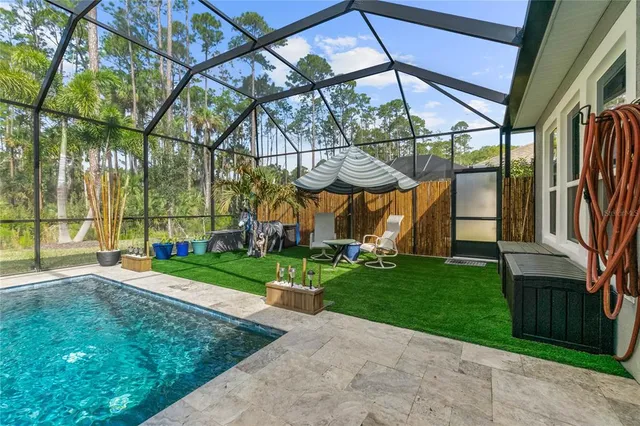 a view of a backyard with swimming pool