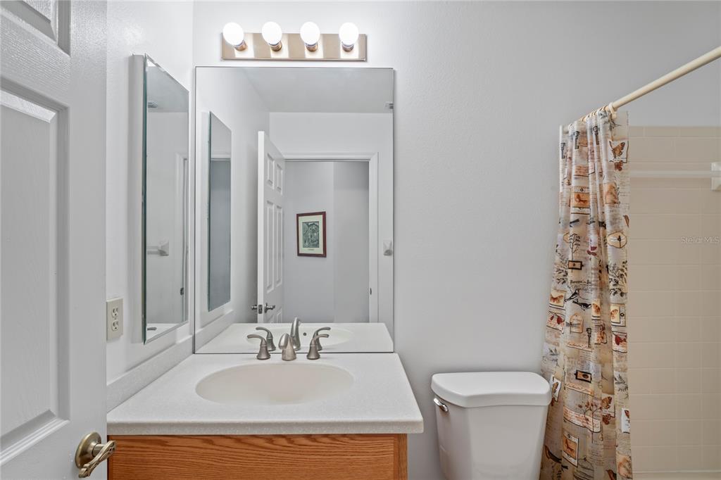 9108 Bassett Lane, Unit B New Port Richey, FL 34655 - Photo 31 of 66 a bathroom with a sink toilet and shower