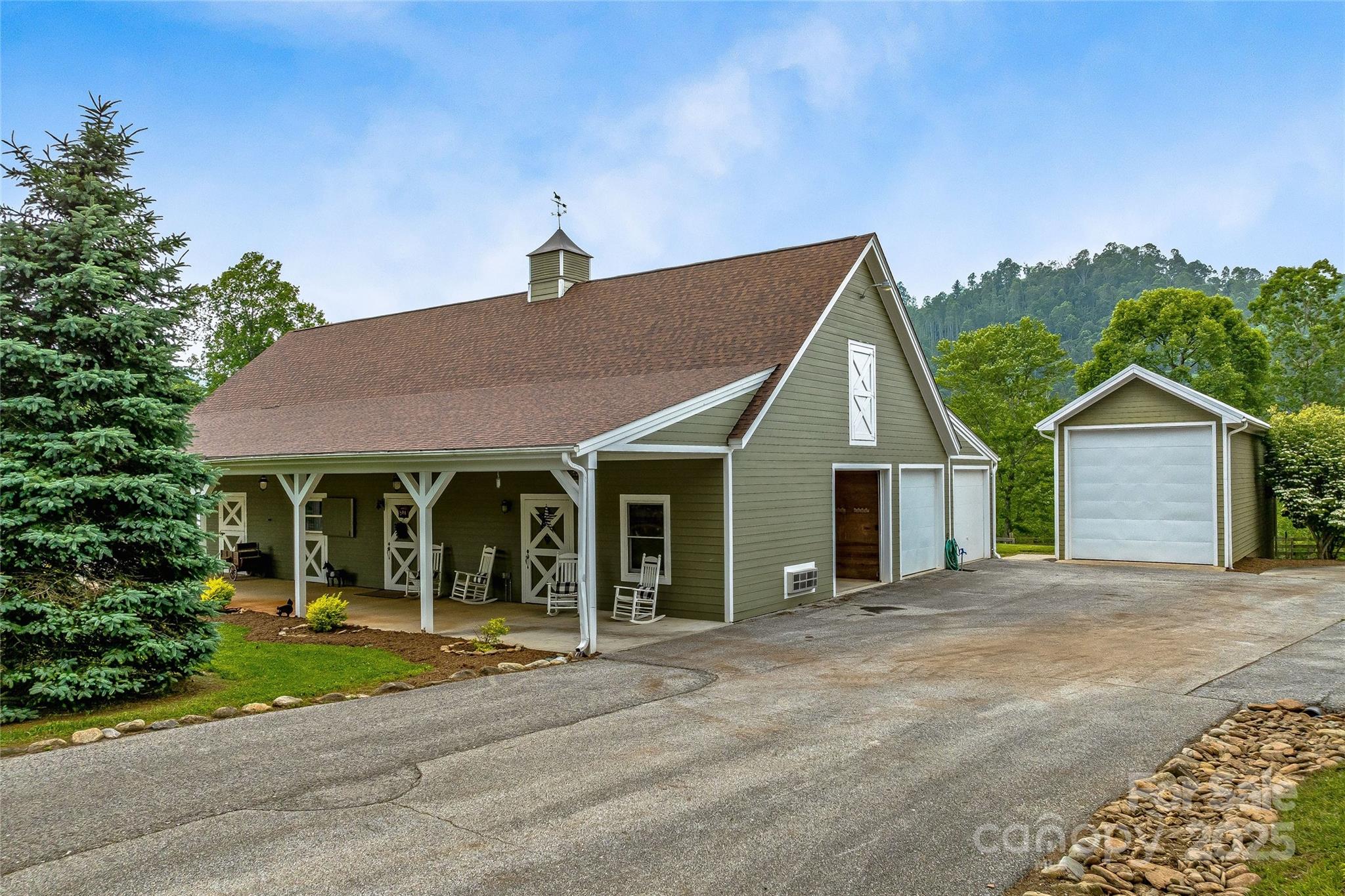 1987 Rabbit Hop Road Spruce Pine, NC 28777 - Photo 11 of 47 a view of a house with a yard and plants
