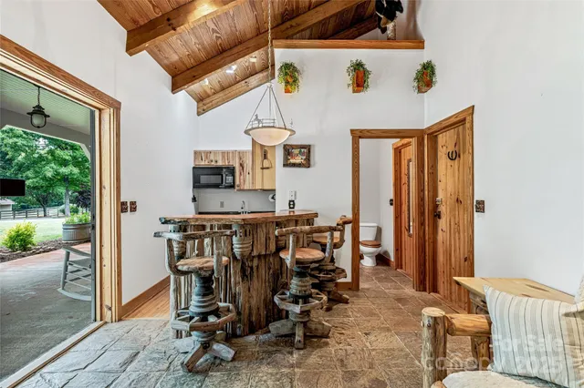 a living room with furniture a fireplace and a table