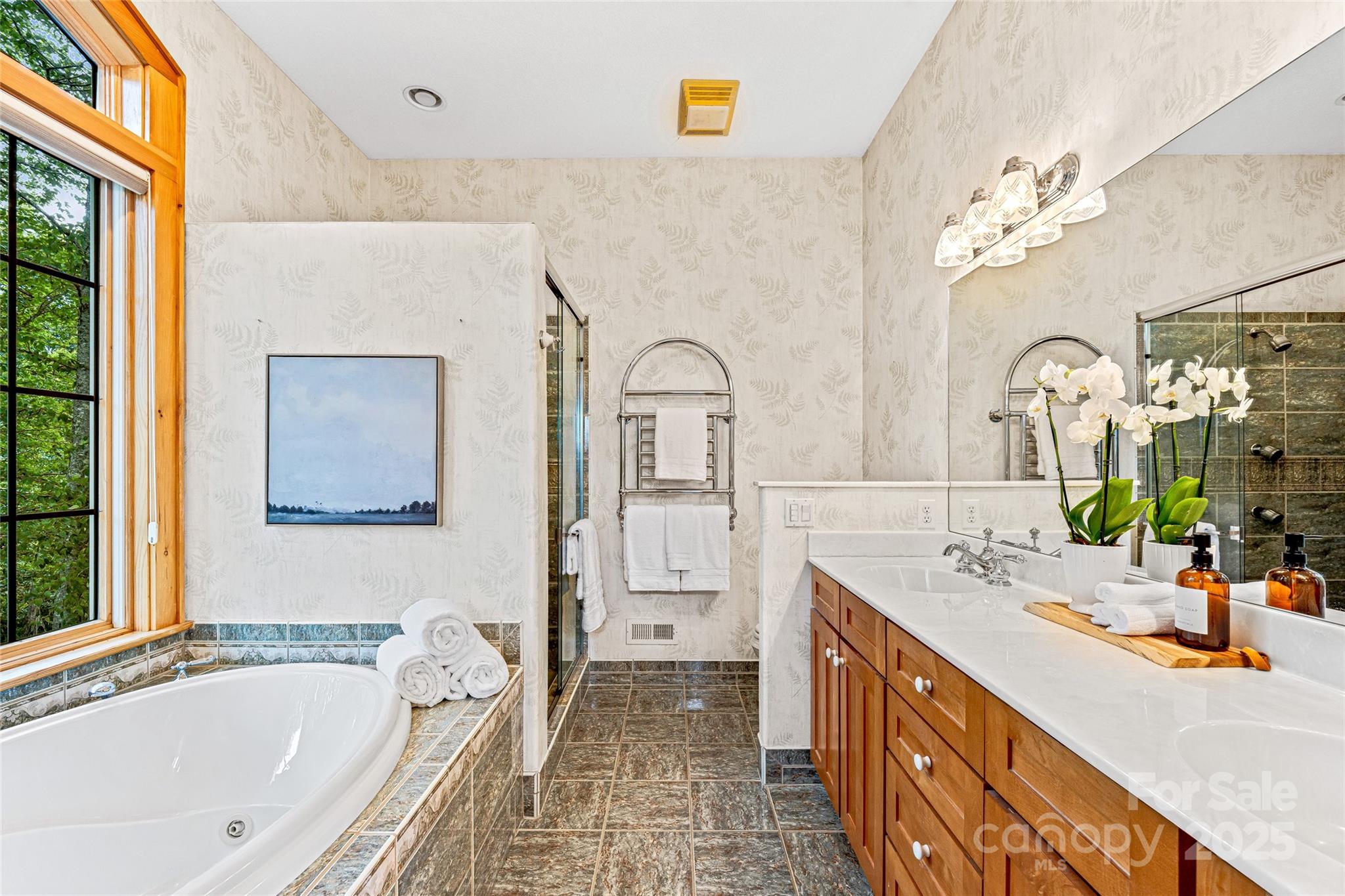 1987 Rabbit Hop Road Spruce Pine, NC 28777 - Photo 32 of 47 a spacious bathroom with a tub double sink and mirror