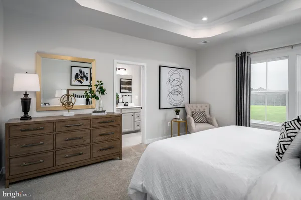 a bedroom with a large bed and a dresser