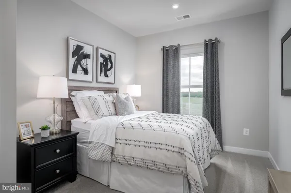a bedroom with a bed and a night stand