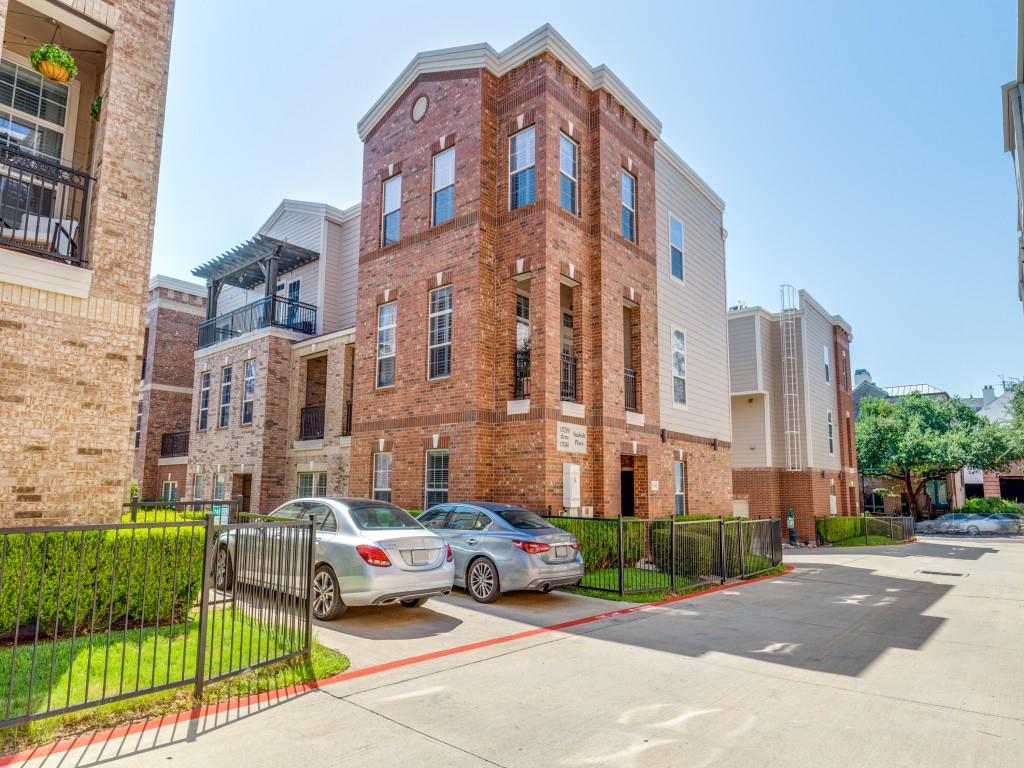 a front view of a building with a garden and plants