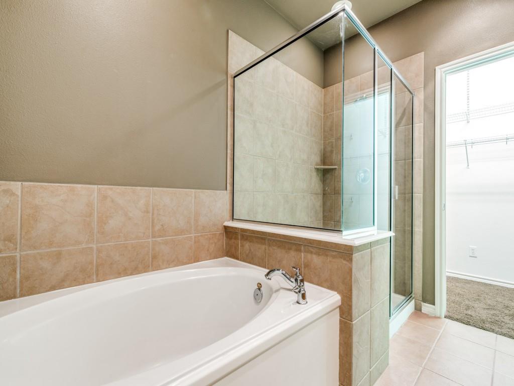 15741 Seabolt Place, Unit 28 Addison, TX 75001 - Photo 19 of 40 a bathroom with a bathtub and a shower